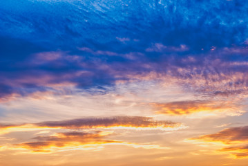 Blue sky and yellowing clouds at sunset