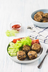 Vegan bean meatballs with vegetables and tomato sauce. Selective focus, space for text.