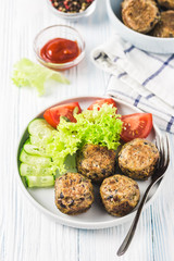 Vegan bean meatballs with vegetables and tomato sauce. Selective focus, space for text.