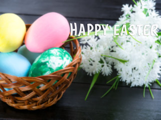 Easter eggs in a basket and white flowers