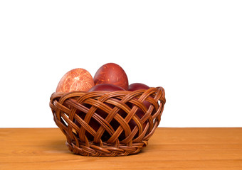 Eggs in a basket on a wooden background. Close-up