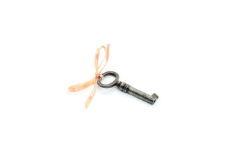 Vintage silver key with pink bow on white