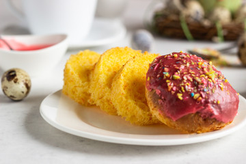 Carrot cake or traditional Orthodox Easter sweet bread with carrot covered pink glaze. Carrot Kulich  decorated with pink glaze.
