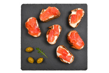 Salmon on a bread with cream isolated on white.