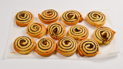 Baked cookies with raisins and poppy seeds isolated on white background.