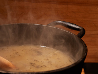 Steaming mushroom soup in a cast iron pot