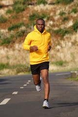 Full body healthy young african american man running on street