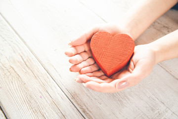 woman hand red heart on the wooden desk
