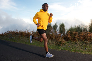 fit young black guy running on street