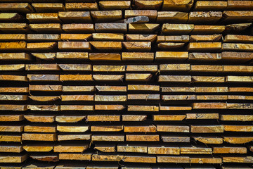 Wooden planks. Beams. Air-drying timber stack. Wood air drying (seasoning lumber or wood seasoning). Timber. Lumber. Close-up. Texture
