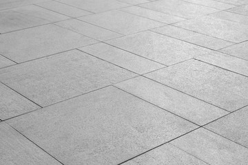 Fototapeta premium Paving stones background. Road texture black and white. Stone flooring. Stone covering on the square.