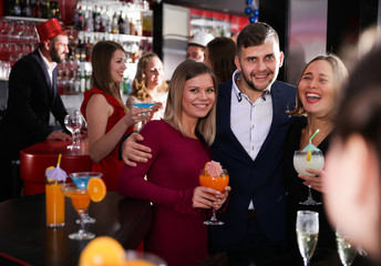 Guy with two girls partying in bar