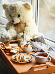 cornflakes, coffee, bread, butter, eggs, jam and other ingredients for breakfast on a dark background. Top view with copy space