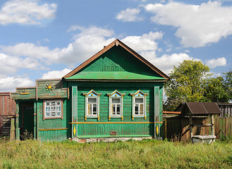 Fototapeta na wymiar Green wooden house in the village