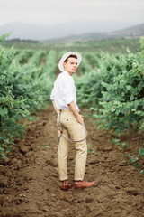 Fototapeta premium Portrait of a gorgeous women and man in the vineyards.