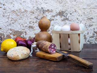 Traditional spanish food on an old wooden table, Iberian pork sausages, bread, eggs, cheese and...