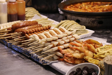 Fried shrimp, sausages and Korean dumplings on the counter. Asia