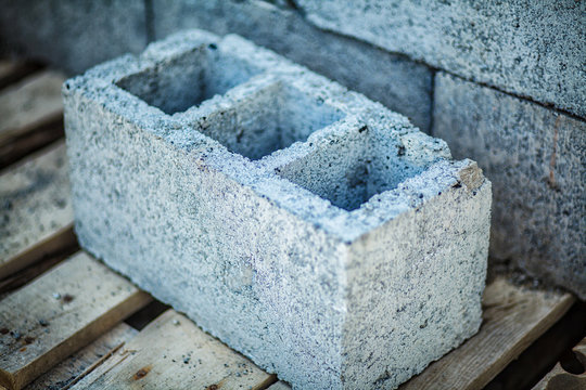 Stack of cement blocks at the construction site. cinder blocks background.