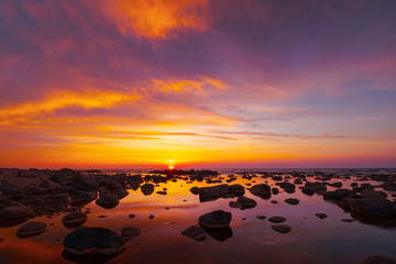 Naklejka na ściany i meble Beautiful sunset at sea side with stones