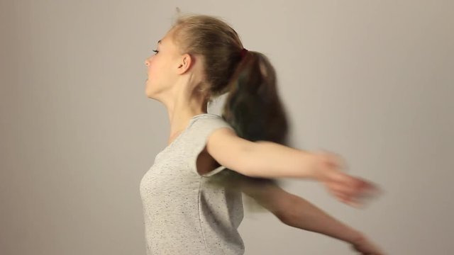 Beautiful girl making a sport exercises. Studio grey background. Sports lifestyle and fitness concept.