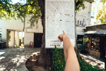 Female hand, points to the map of the city.