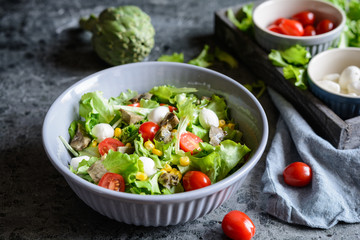 Healthy salad with baked artichoke, Mozzarella, tomatoes and corn