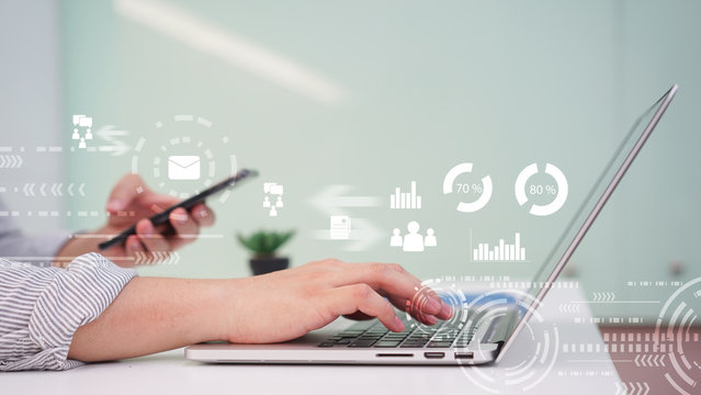 close up businessman hand working on laptop with financial data dashboard for technology concept