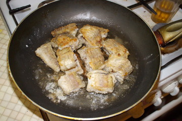 fried fish cooking in a pan