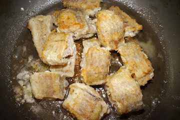 fried fish cooking in a pan