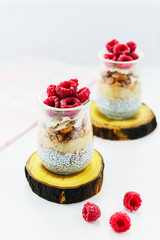 Chia pudding with raspberries, banana and coconut. Healthy superfood for breakfast