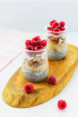 Chia pudding with raspberries, banana and coconut. Healthy superfood for breakfast