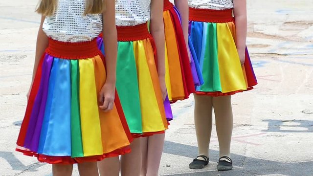Dancing in multicolored skirts girls. Slow motion.