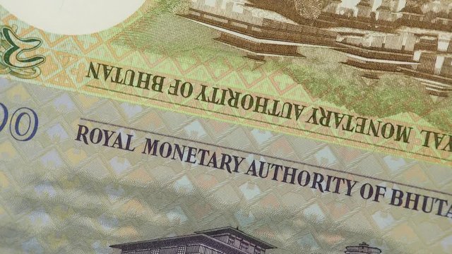 Bhutan ngultrum banknotes rotating. Bhutanese currency, money, market. 4K stock video footage