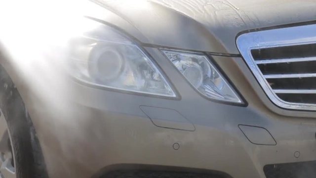 contactless washing of car headlights under pressure