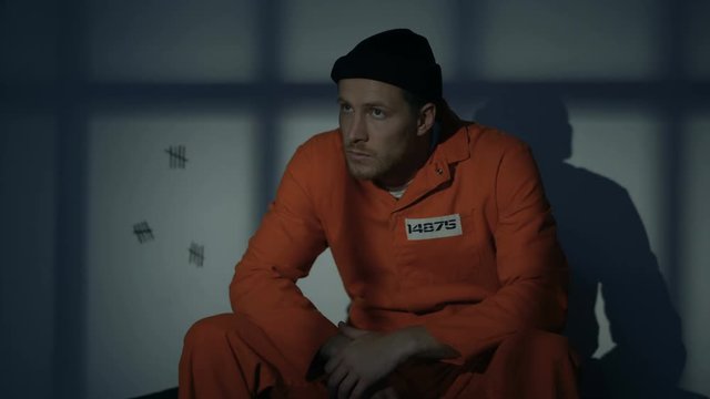 Caucasian imprisoned man escaping prison when red light blinking, riot in jail