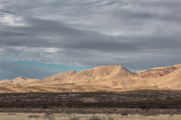 Fototapeta na wymiar Bosque del Apache New Mexico, mountains before dark skies in winter, horizontal aspect