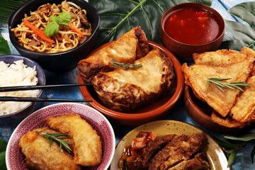 Assorted Chinese food set. Chinese noodles, fried rice, peking duck, dim sum, spring rolls. Famous Chinese cuisine dishes on table. Chinese restaurant