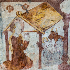 Mary is kneeling in front of the newborn child. Gothic fresco from the 1400s in a swedish church.