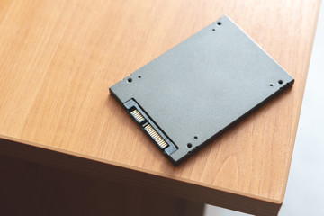 solid-state drive at wooden table. ssd for desktop or laptop upgrade hardware.