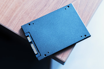 solid-state drive at wooden table. ssd for desktop or laptop upgrade hardware.