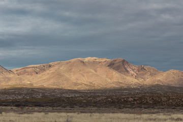 Fototapeta na wymiar Bosque del Apache view of New Mexico mountain range before darkening skies, horizontal aspect
