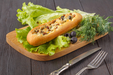 Baguette stuffed with bolognese ragout of minced beef, tomatoes and cheese. A delicious Italian lunch, tasty snacks, homemade sandwich