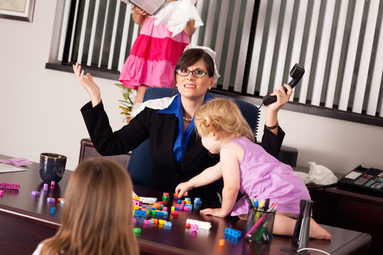 Stressed Businesswoman with Children in Office - Working Mom