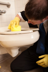 Businessman Cleaning Women's Public Restroom Toilet