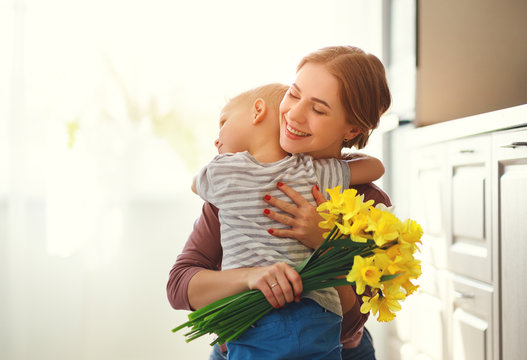 happy mother's day! child son gives flowersfor  mother on holiday .