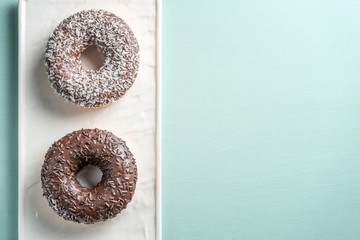 Two donuts on a blue background, copy space.