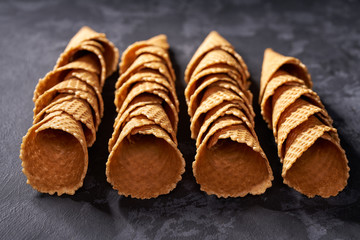 High angle view of hand made waffle ice cream cones in a row, selective focus.