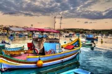 Evening Malta, village of fishermen, color boats