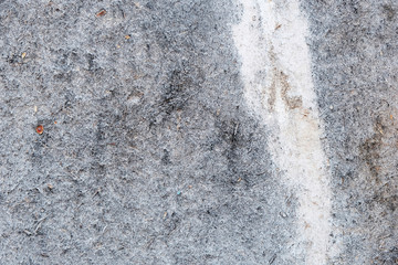 Pale blue stone texture of the wall. White paint stain on the surface. Copyspace.