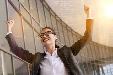 businesswoman happy to win and arms raised 